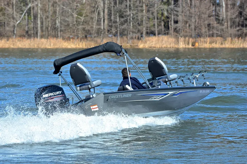 Slide: The Image of 2017 Crestliner VT 17 boat cruising on a lake with Mercury outboard motor. - 5