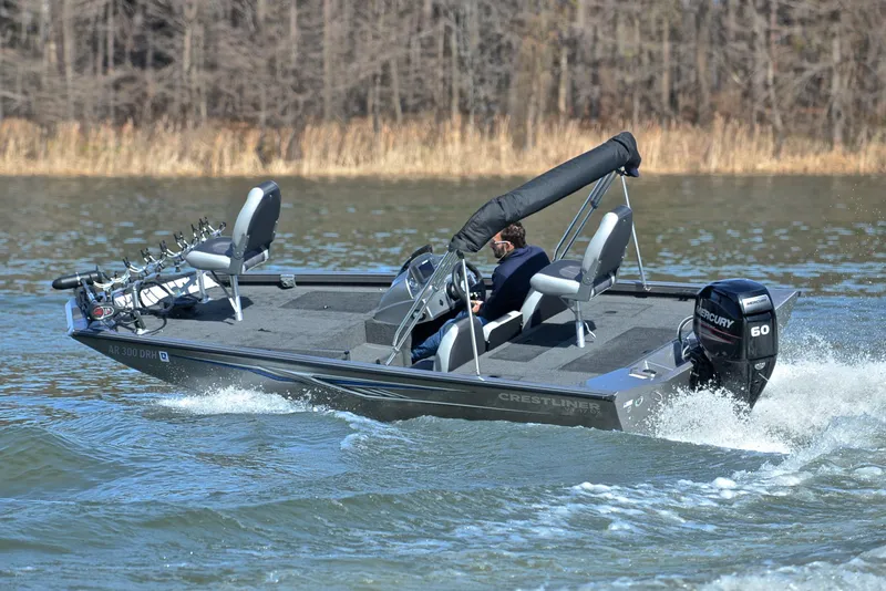 Slide: The Image of 2017 Crestliner VT 17 boat cruising on a lake with Mercury outboard motor. - 6