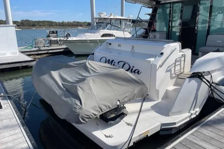 Slide: The Image of 2019 Tiara Yachts F53 Flybridge cruising on open water under clear skies. - 1