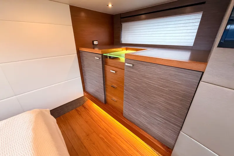Slide: The Image of 2019 Tiara Yachts F53 Flybridge interior with modern wood cabinetry and ambient lighting. - 103
