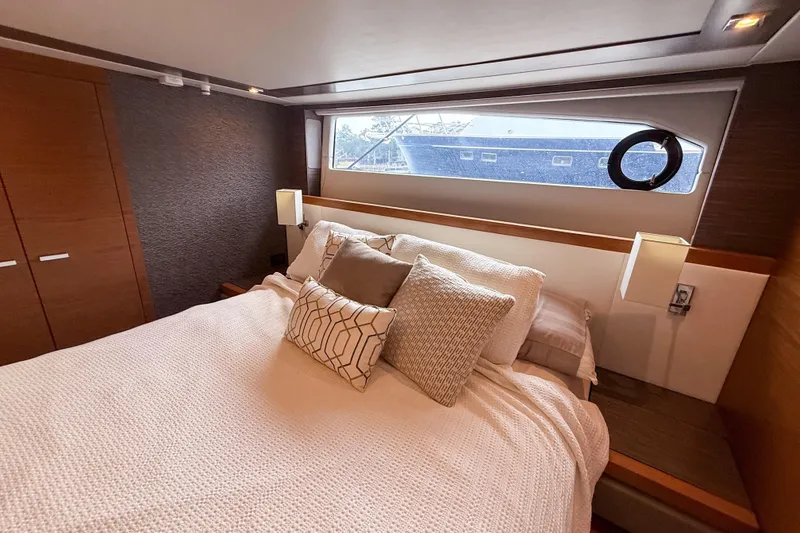Slide: The Image of Luxurious bedroom interior of 2019 Tiara Yachts F53 Flybridge with elegant bedding and window view. - 105