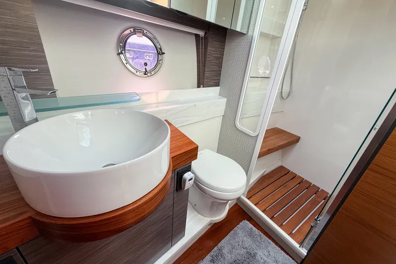 Slide: The Image of Luxurious bathroom in 2019 Tiara Yachts F53 Flybridge with modern fixtures and wooden accents. - 111