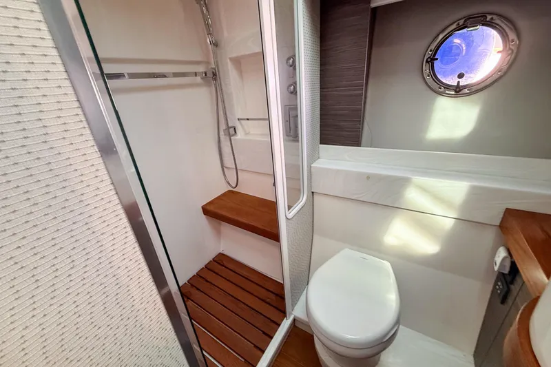Slide: The Image of Luxurious bathroom in 2019 Tiara Yachts F53 Flybridge with shower and porthole window. - 114