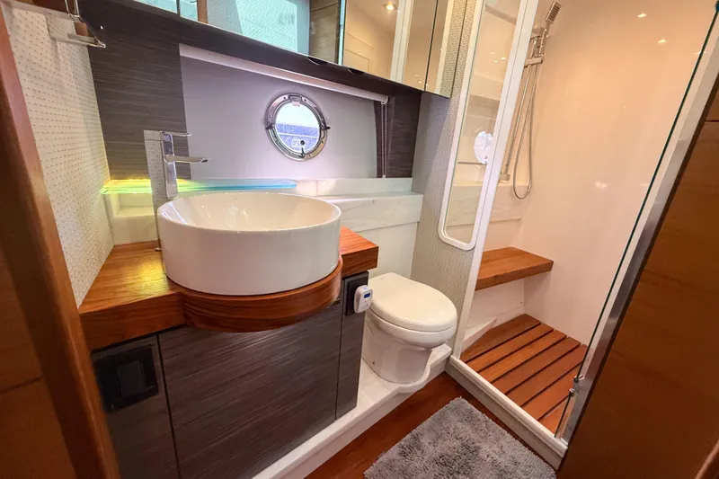 Slide: The Image of Luxurious bathroom in 2019 Tiara Yachts F53 Flybridge with modern fixtures and wooden accents. - 118