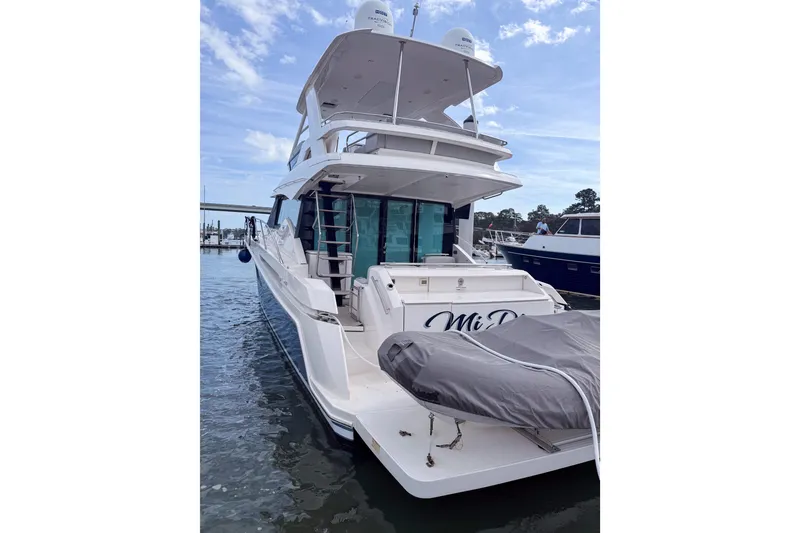 Slide: The Image of 2019 Tiara Yachts F53 Flybridge docked, showcasing sleek design and spacious flybridge. - 124