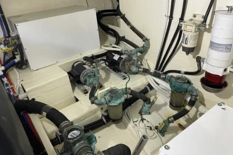 Slide: The Image of Engine room of 2019 Tiara Yachts F53 Flybridge with visible pumps and filters. - 125