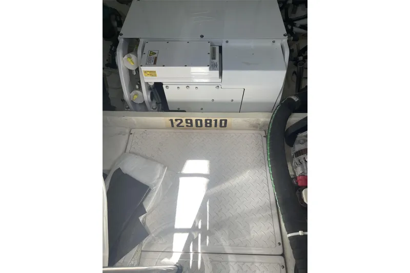 Slide: The Image of Engine room of 2019 Tiara Yachts F53 Flybridge with equipment and serial number. - 126