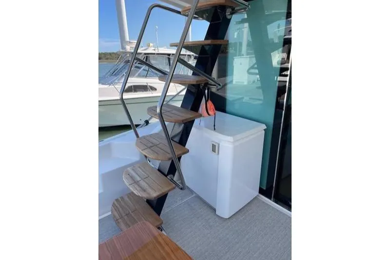 Slide: The Image of 2019 Tiara Yachts F53 Flybridge cruising on open water. - 18