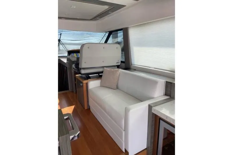 Slide: The Image of 2019 Tiara Yachts F53 Flybridge cruising on open water. - 19