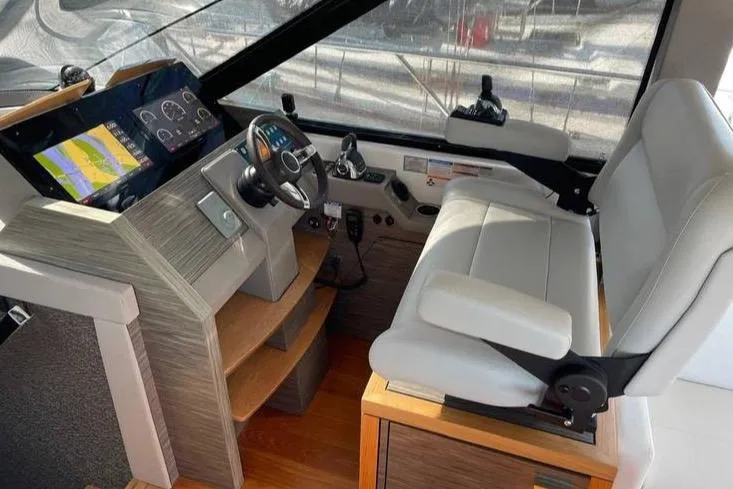 Slide: The Image of 2019 Tiara Yachts F53 Flybridge cruising on open water. - 20