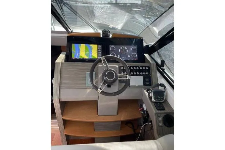 Slide: The Image of 2019 Tiara Yachts F53 Flybridge cruising on open water, showcasing sleek design and luxury features. - 21