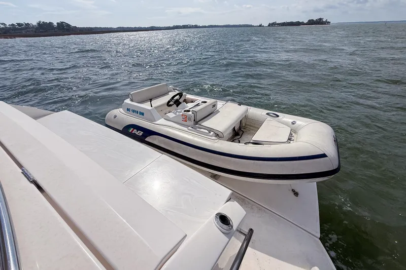 Slide: The Image of 2019 Tiara Yachts F53 Flybridge with inflatable boat on water. - 35