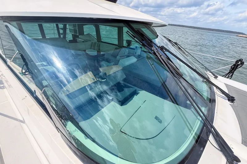 Slide: The Image of 2019 Tiara Yachts F53 Flybridge yacht with sleek windshield design on open water. - 39
