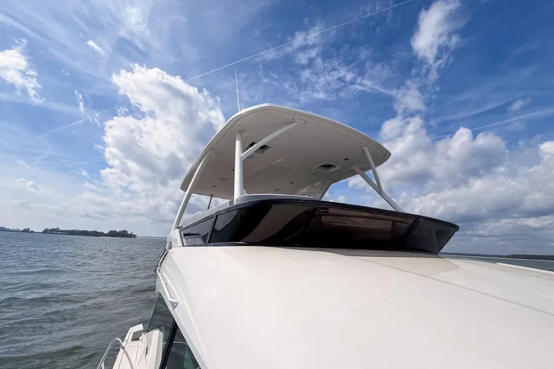 Slide: The Image of 2019 Tiara Yachts F53 Flybridge on open water under a blue sky. - 41