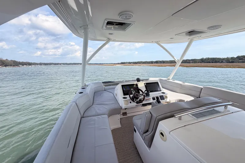 Slide: The Image of 2019 Tiara Yachts F53 Flybridge helm with panoramic water view. - 46