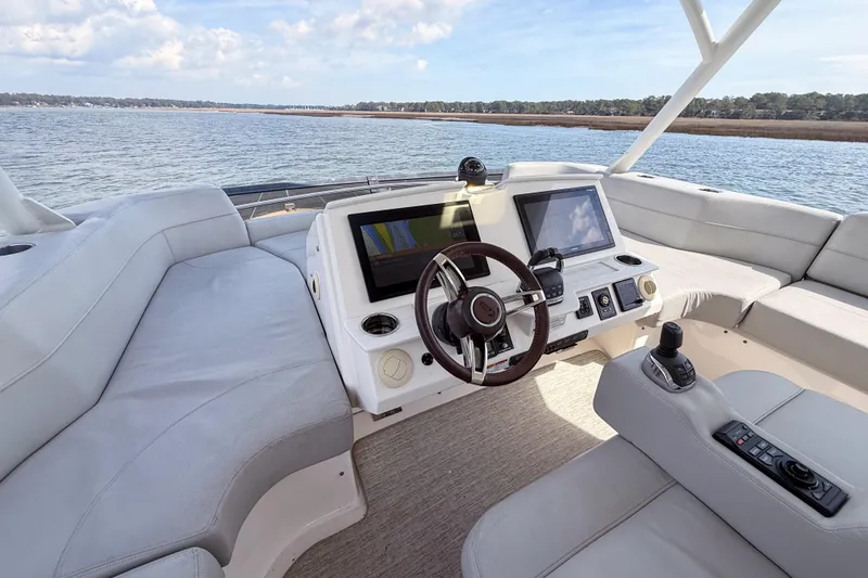 Slide: The Image of 2019 Tiara Yachts F53 Flybridge helm with modern controls and scenic water view. - 47