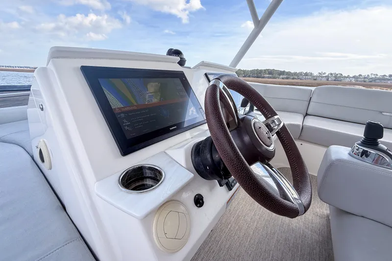 Slide: The Image of 2019 Tiara Yachts F53 Flybridge helm with modern controls and navigation display. - 49