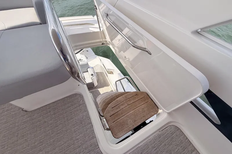 Slide: The Image of 2019 Tiara Yachts F53 Flybridge helm station with wooden step detail. - 52