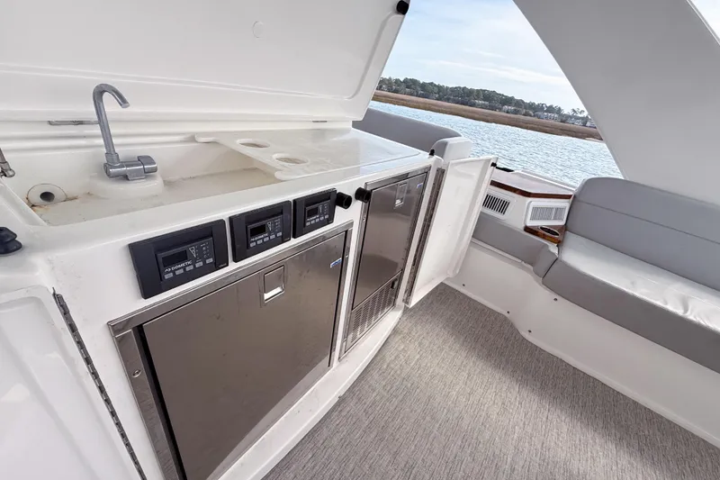 Slide: The Image of 2019 Tiara Yachts F53 Flybridge interior with kitchenette and seating area. - 53