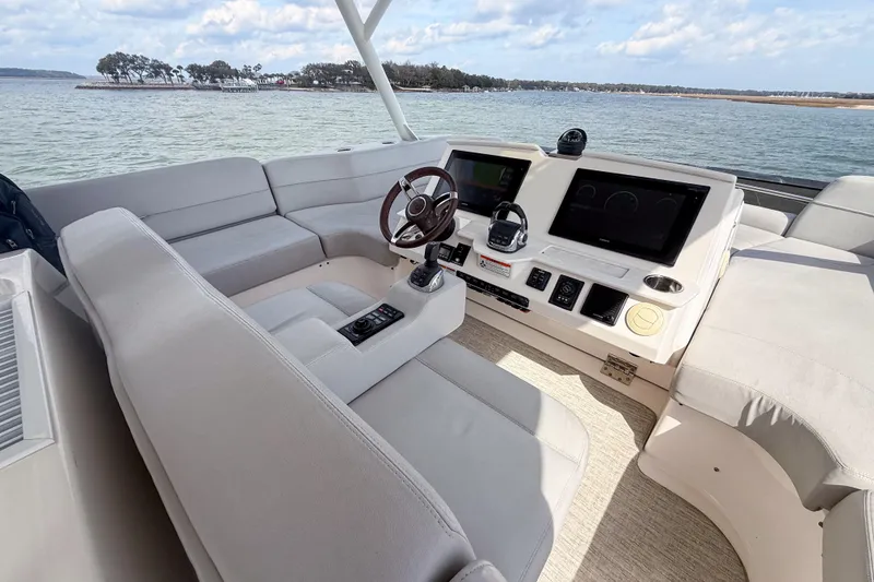 Slide: The Image of 2019 Tiara Yachts F53 Flybridge helm with modern controls and panoramic water view. - 55