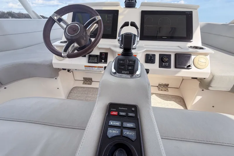 Slide: The Image of 2019 Tiara Yachts F53 Flybridge helm with modern controls and navigation displays. - 56