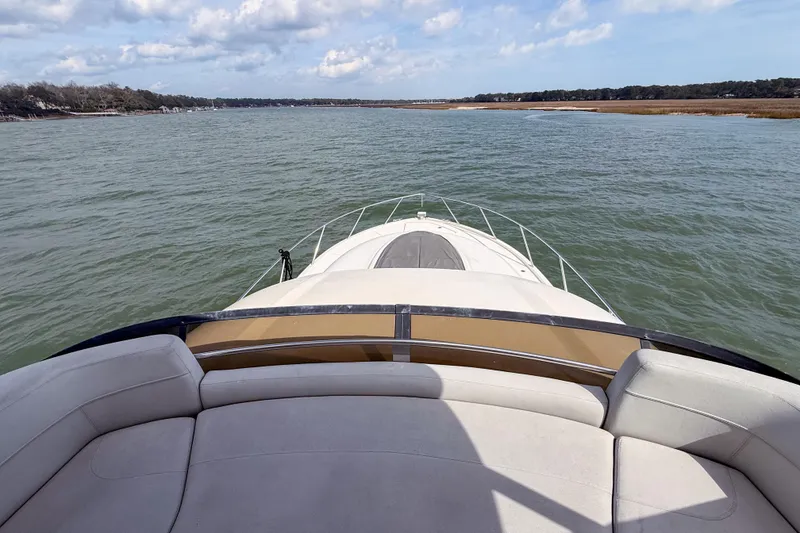 Slide: The Image of 2019 Tiara Yachts F53 Flybridge cruising on calm waters under a partly cloudy sky. - 57