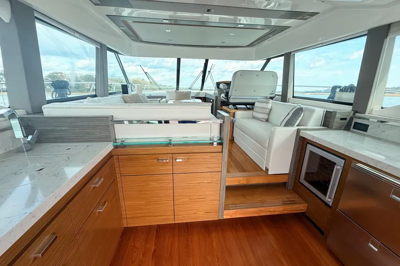 Slide: The Image of Luxurious interior of 2019 Tiara Yachts F53 Flybridge with modern kitchen and seating area. - 62
