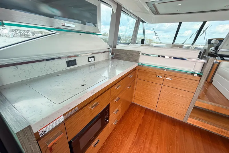 Slide: The Image of Luxurious 2019 Tiara Yachts F53 Flybridge interior with modern kitchen and sleek design. - 63