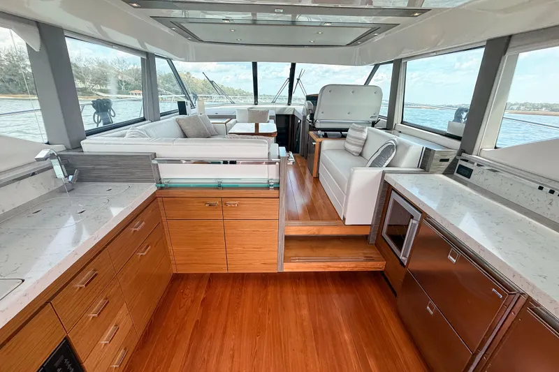 Slide: The Image of Luxurious interior of 2019 Tiara Yachts F53 Flybridge with modern kitchen and seating area. - 64