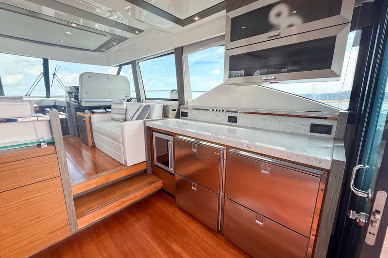 Slide: The Image of Luxurious interior of 2019 Tiara Yachts F53 Flybridge with modern kitchen and seating area. - 66