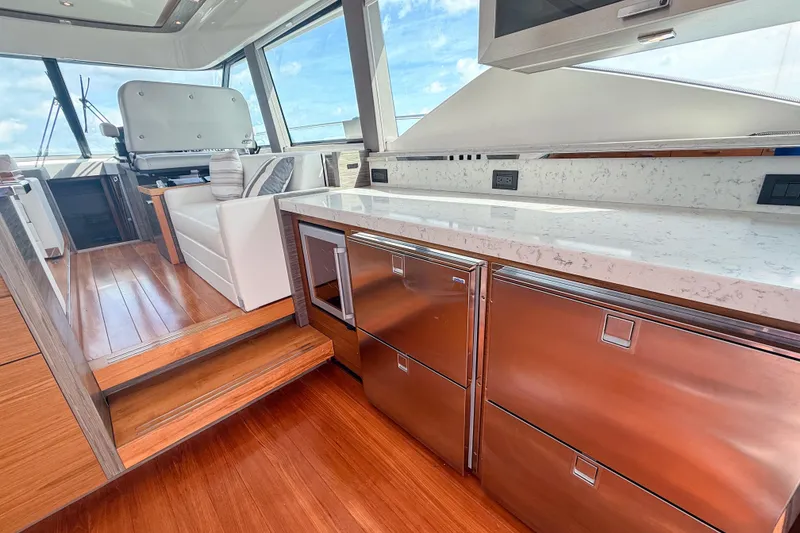 Slide: The Image of Luxurious interior of 2019 Tiara Yachts F53 Flybridge with modern kitchen and seating area. - 67