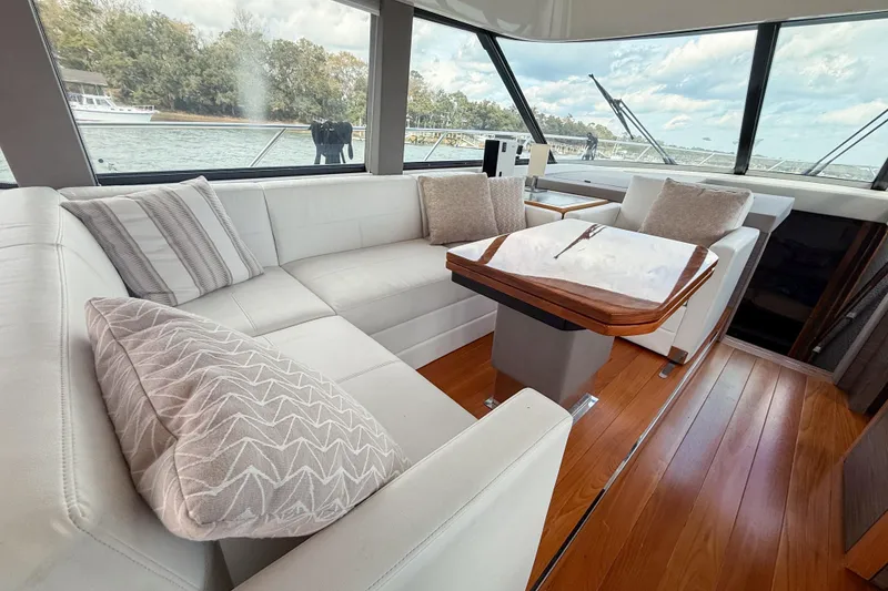 Slide: The Image of Luxurious interior of 2019 Tiara Yachts F53 Flybridge with elegant seating and wooden table. - 68