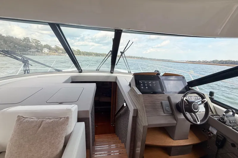 Slide: The Image of Interior view of 2019 Tiara Yachts F53 Flybridge helm with modern controls and scenic waterway. - 71