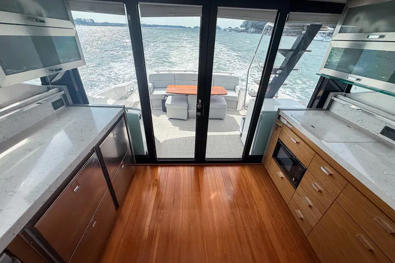 Slide: The Image of Luxurious 2019 Tiara Yachts F53 Flybridge interior with modern kitchen and scenic ocean view. - 74