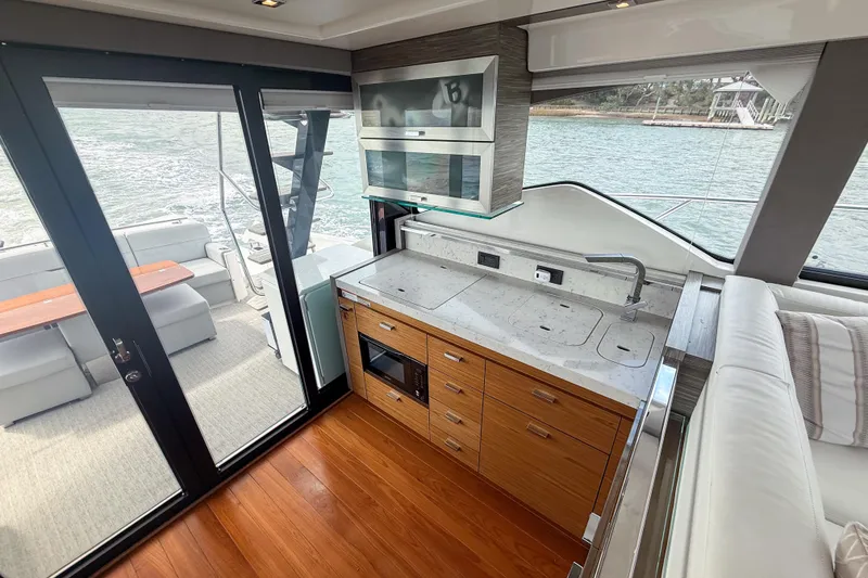 Slide: The Image of Luxurious 2019 Tiara Yachts F53 Flybridge interior with modern kitchen and outdoor seating. - 76