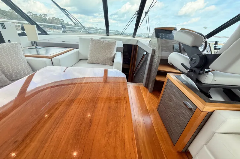 Slide: The Image of Luxurious interior of 2019 Tiara Yachts F53 Flybridge with polished wood and plush seating. - 78