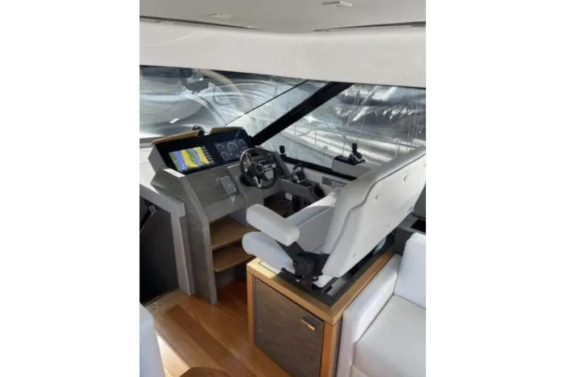 Slide: The Image of 2019 Tiara Yachts F53 Flybridge cruising on open water. - 8