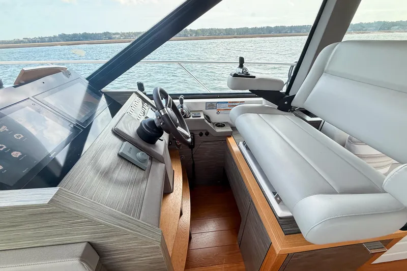 Slide: The Image of 2019 Tiara Yachts F53 Flybridge helm with modern controls and comfortable seating. - 81