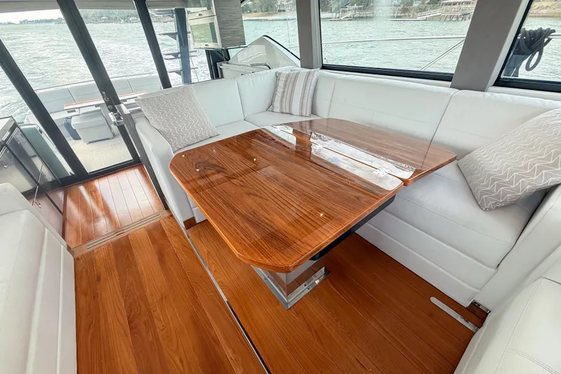 Slide: The Image of Luxurious interior of 2019 Tiara Yachts F53 Flybridge with elegant wood table and white seating. - 83