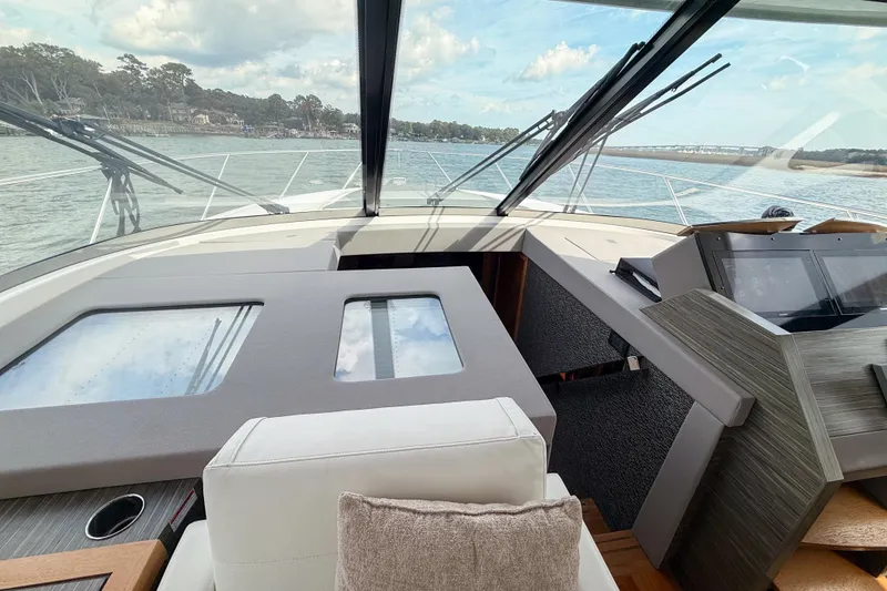 Slide: The Image of 2019 Tiara Yachts F53 Flybridge helm with panoramic water view. - 84