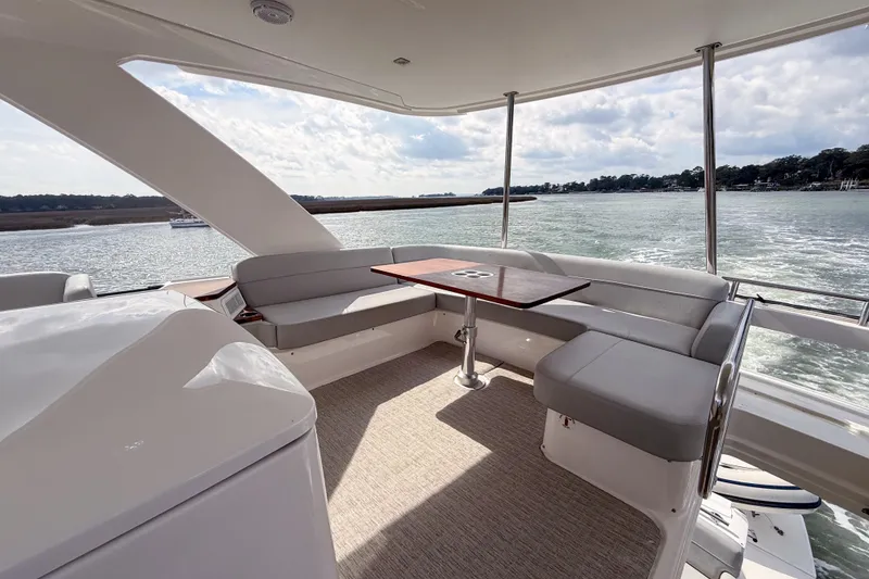 Slide: The Image of Luxurious 2019 Tiara Yachts F53 Flybridge with spacious seating and scenic water views. - 88