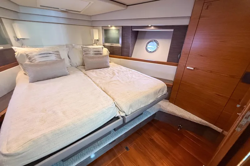 Slide: The Image of Luxurious bedroom interior of 2019 Tiara Yachts F53 Flybridge with elegant bedding and wood finishes. - 93
