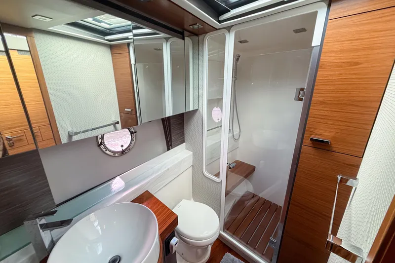 Slide: The Image of Luxurious bathroom in 2019 Tiara Yachts F53 Flybridge with modern fixtures and wood accents. - 98