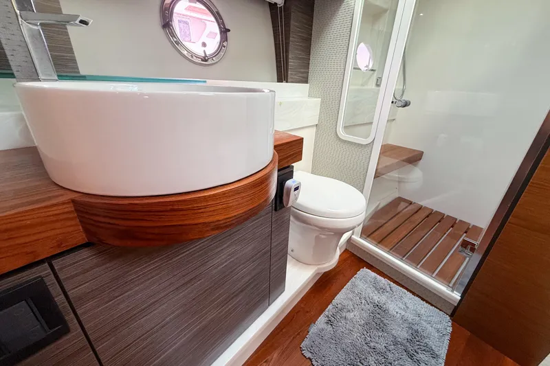Slide: The Image of Luxurious bathroom in 2019 Tiara Yachts F53 Flybridge with modern fixtures and wooden accents. - 99