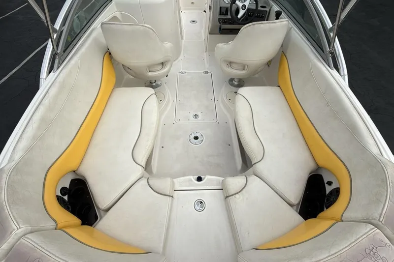 Slide: The Image of 2005 Monterey 233 Explorer Sport boat interior with white and yellow seating. - 10