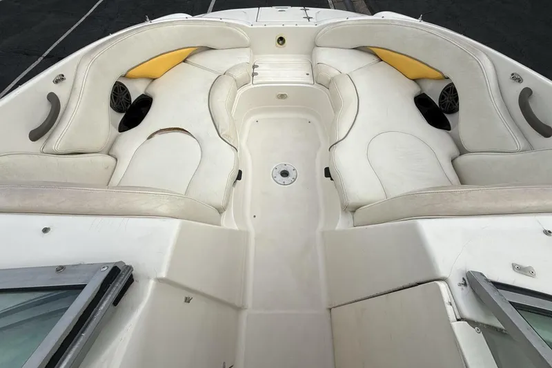 Slide: The Image of 2005 Monterey 233 Explorer Sport boat interior with white seating and speakers. - 11