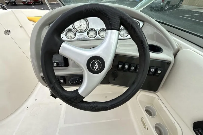 Slide: The Image of Steering wheel and dashboard of 2005 Monterey 233 Explorer Sport boat. - 14