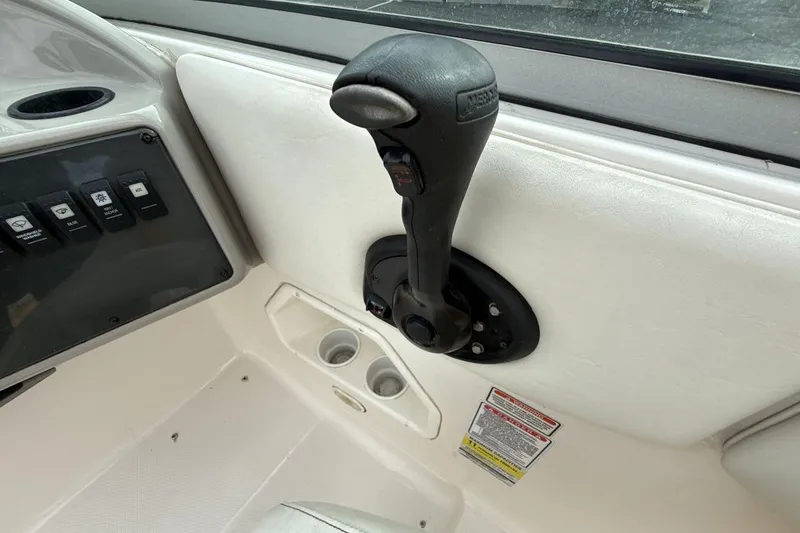 Slide: The Image of 2005 Monterey 233 Explorer Sport boat throttle control and dashboard switches. - 16