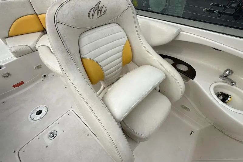 Slide: The Image of 2005 Monterey 233 Explorer Sport boat interior with white and yellow seating. - 17