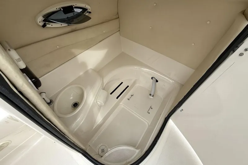 Slide: The Image of 2005 Monterey 233 Explorer Sport boat interior with sink and porthole. - 18